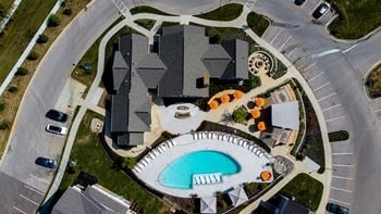A large building with a pool in front of it.